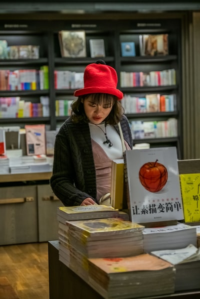 A woman with a red hat in the check book
